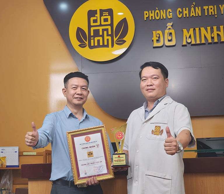 Lương y Tuấn (trái) và lương y Lâm (phải) đang cầm giải thưởng Top 10 Thương hiệu mạnh Quốc gia 2024 của Nhà thuốc Đỗ Minh Đường